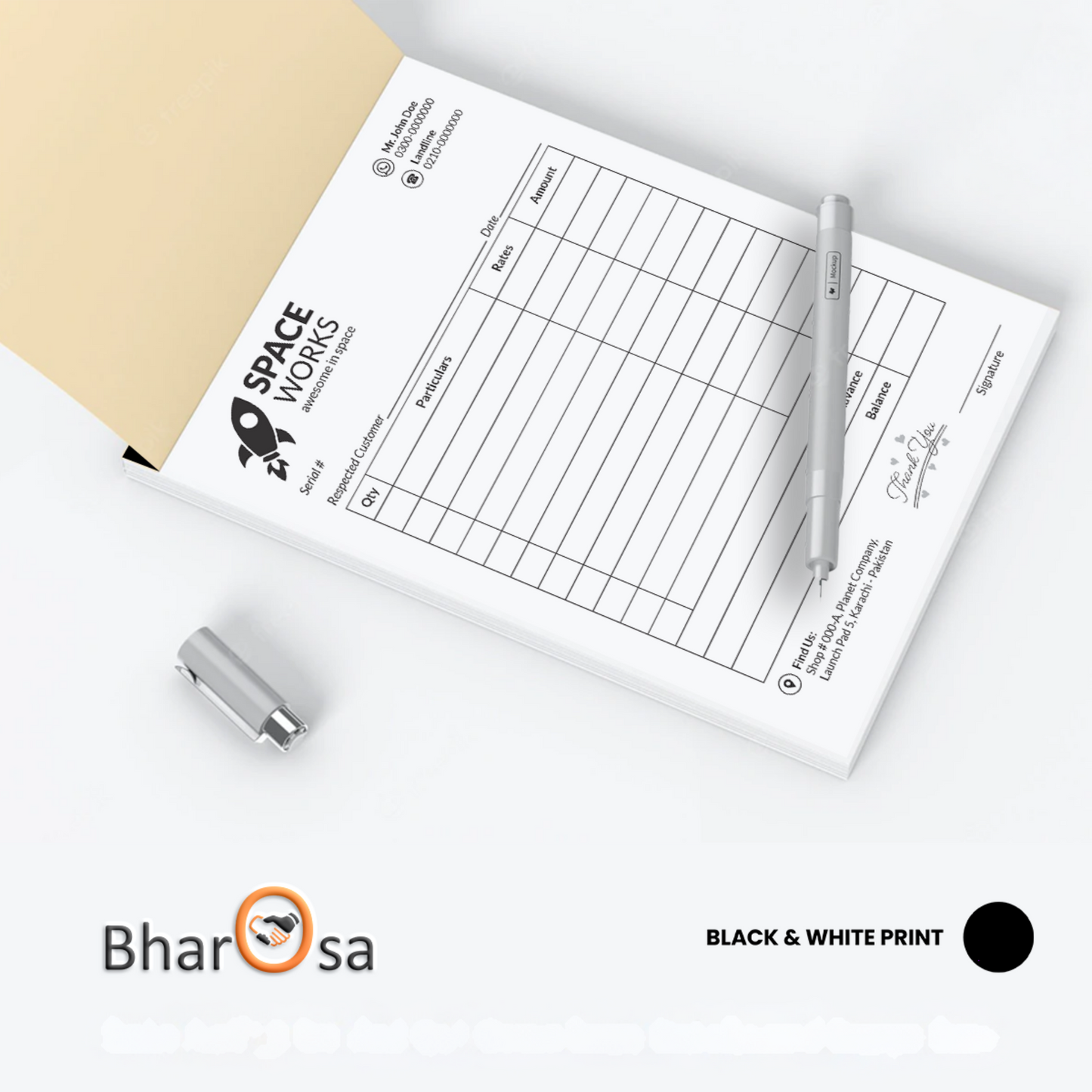 A5 size bill book with a pen and a small amount of carbon paper placed on top, indicating its use for keeping financial records.