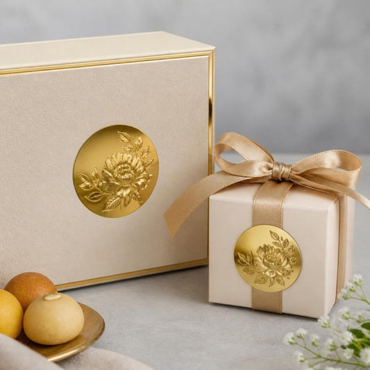 Shiny golden stickers as seals on sweets and wedding boxes