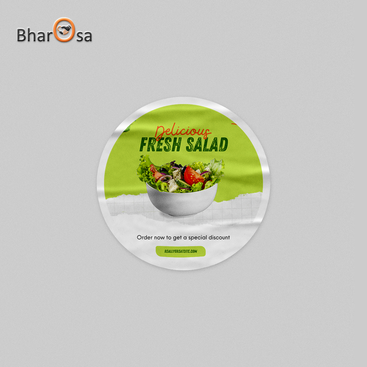 Round promotional sticker for Bharosa with a salad image on a gray background